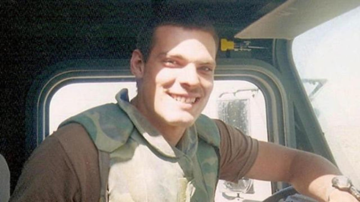 Justin Huff smiling while in khaki uniform