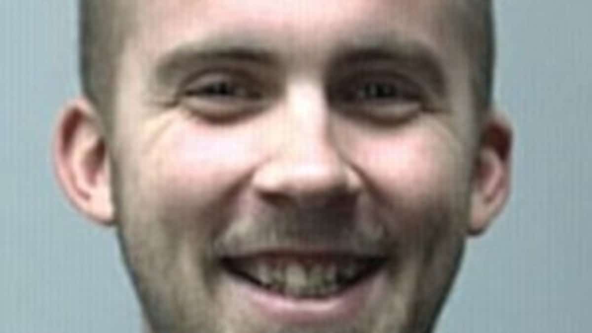 Mugshot of a grinning Jeffrey Vogelsberg