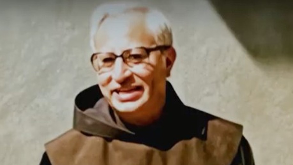 Father Rivera smiling in priests robes