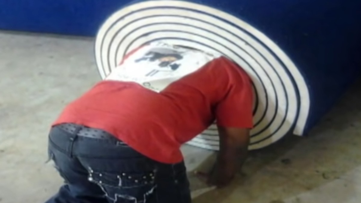 Kenneth Johnson tries to squeeze into a mat