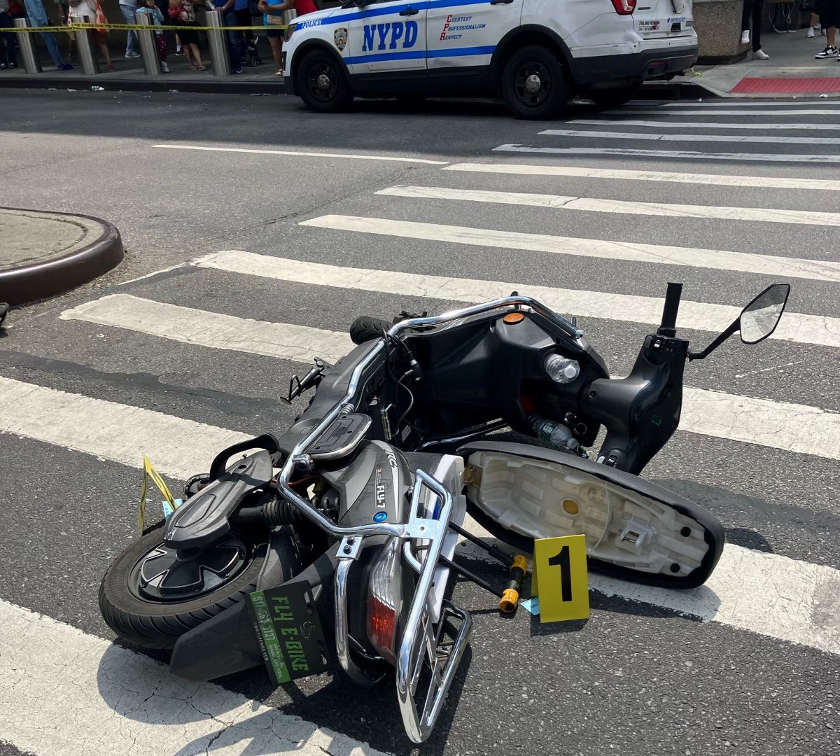 A scooter lying on an NY street