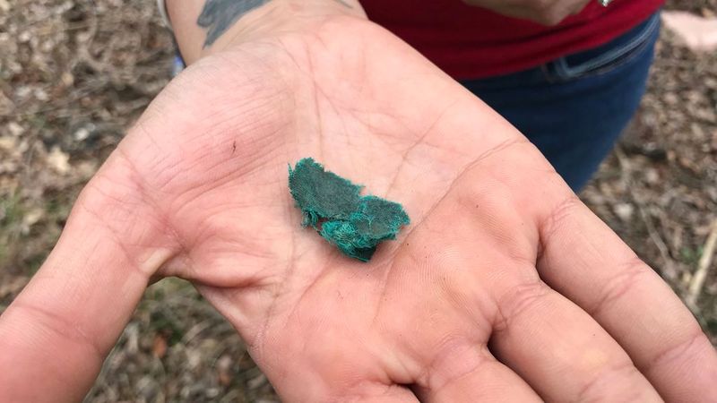 A piece of green cloth in a family member's hand