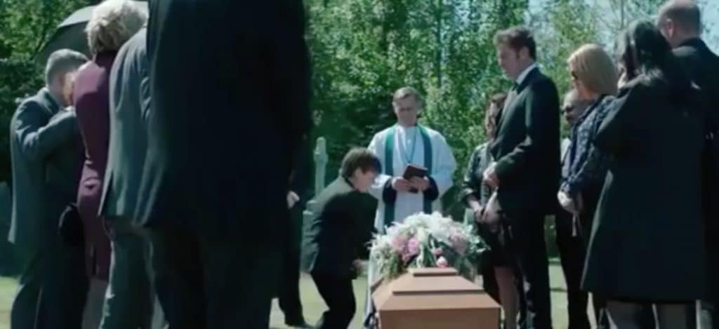 A scene from the movie shows the grieving family burying their daughter