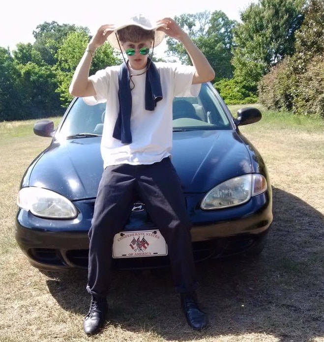 Roof with his car, note the number plate